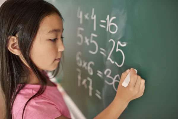 Focus girl trying to solve mathematical equation